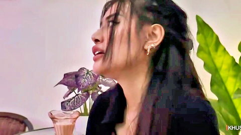 Seductive Asian woman in black outfit, long dark hair, profile pose