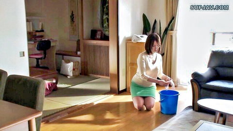 Japanese MILF kneeling in green skirt and white blouse holding bucket