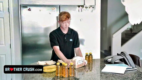 Cute freckled redhead twink stands in kitchen with bananas and honey bottles on counter for Brother Crush