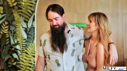 Blonde MILF in pink slip dress hugs smiling bearded man in Hawaiian shirt with huge tits cleavage