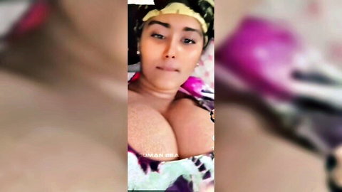 Ebony BBW with massive tits bursting from low-cut pink top in teasing selfie
