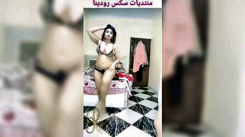 Egyptian amateur wife teasing in black bra and thong on pink bed