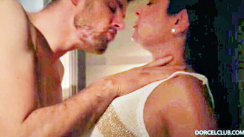 Bearded stud passionately kisses busty MILF's neck while grabbing her throat showing cleavage