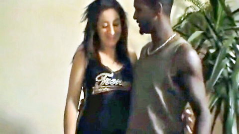 Curvy brunette in Porn tank top embraces muscular black stud in teasing interracial pose