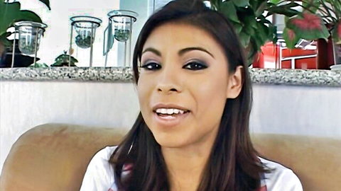 Sexy smiling Latina brunette with full lips and heavy makeup teasing in white top