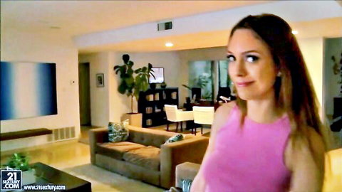 August Ames smiling in pink tank top, teasing in luxurious home
