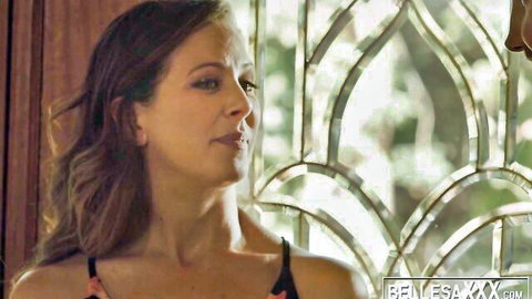 Seductive mature brunette Cherie DeVille in black dress, erotic gaze