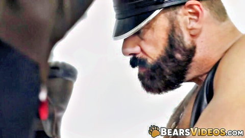 Steve Sommers in leather cap dominates muscular John Pucker close-up