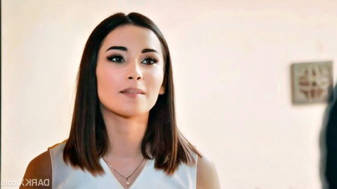 Aria Cheer woman in white sleeveless top, seductive gaze