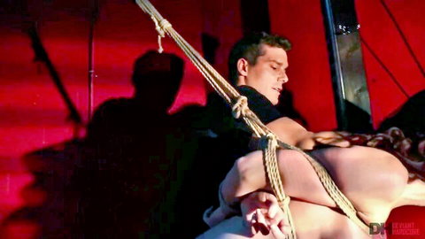 Bound couple in intense BDSM rope suspension play