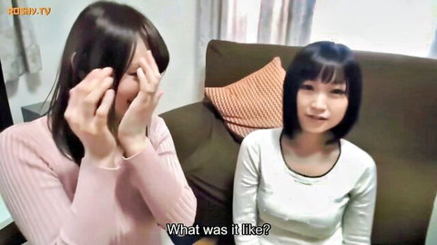 Two Japanese women laughing on couch in JAV interview scene