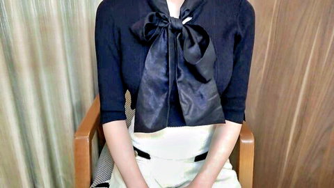 Shy Japanese announcer hiding face in elegant navy blouse with bow tie