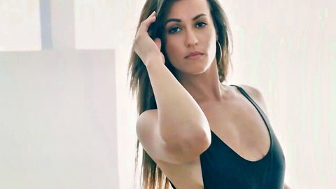 Seductive brunette with cleavage posing in black tank top