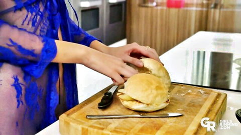 Lina Luxa in sheer blue lace lingerie seductively preparing a burger