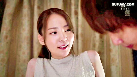 Asian woman in off-shoulder top smiling intimately with man in JAV family roleplay scene