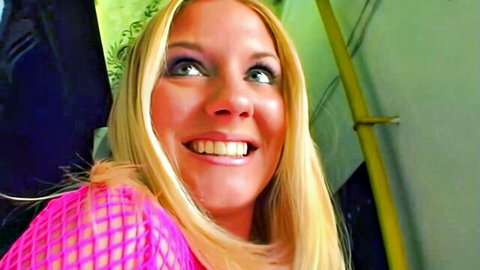 Blonde Carrie Cruise smiling in revealing pink mesh top