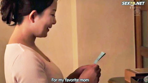 Smiling Asian MILF holding card 'For my favorite mom' in tight top