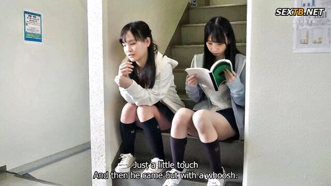 Two cute Japanese teen schoolgirls in short skirt uniforms sitting on stairs reading book teasing thighs