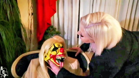 Blonde babe leans in as clown-masked perv gropes her thick thigh and ass