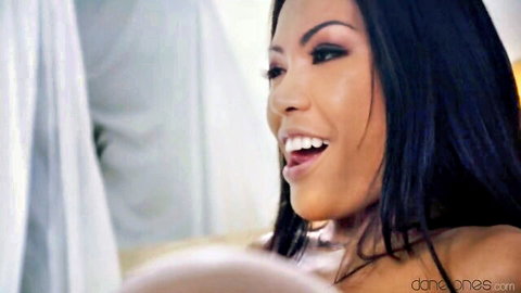 Hot Asian babe smiling with open mouth in ecstatic pleasure closeup