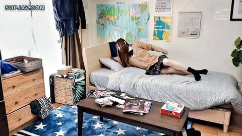 Brunette Japanese teen girlfriend lying on bed with short skirt up exposing panty-covered ass