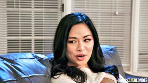 Asian brunette with small tits pulls down top exposing cleavage on couch
