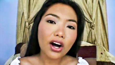 Asian beauty with long hair and cleavage opens wide mouth for blowjob tease