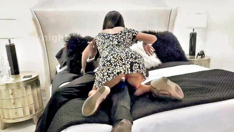 Asian hottie in short floral dress rides man's lap reverse cowgirl exposing juicy ass and black thong on bed