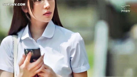 Karen Kaede in white school uniform blouse, holding phone seductively