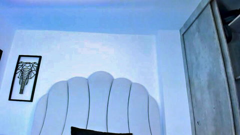 Kaity Layne in elegant white bedroom setup with scalloped headboard