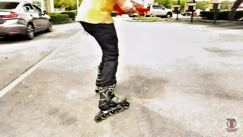 Sisi Rose athletic jump in tight pants on rollerblades outdoors