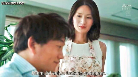 Asian couple in casual indoor chat, woman in floral apron