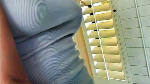 Kacey Kox in tight blue ribbed dress, side view curves