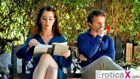 Evelyn Claire in blue dress reading with hubby on bench - EroticaX