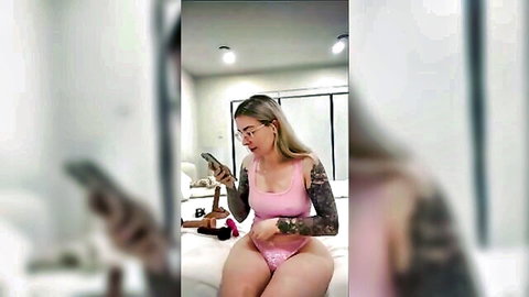 Jen Bretty blonde in pink lingerie teasing on bed during livestream