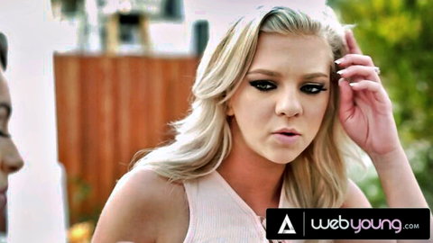 Shocked blonde teen with pouty lips and smoky eyes touching face outdoors