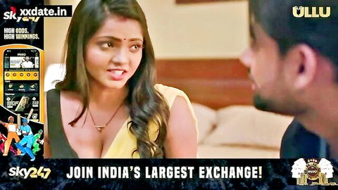 Sexy Indian MILF in yellow saree blouse with deep cleavage glares intensely at man in bedroom