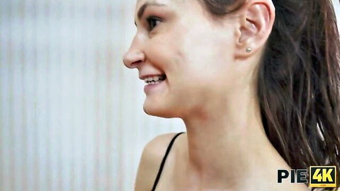 Nicole Murkovski smiling in profile, brunette in black lingerie