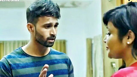 Indian man in blue shirt gesturing to short-haired woman in red top, intense couple moment