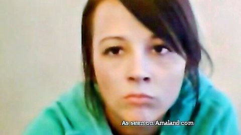 Close-up of cute brunette teen pouting in teal hoodie on webcam