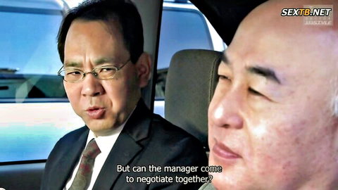 Two suited Asian men in a car discussing manager negotiation in JAV scene