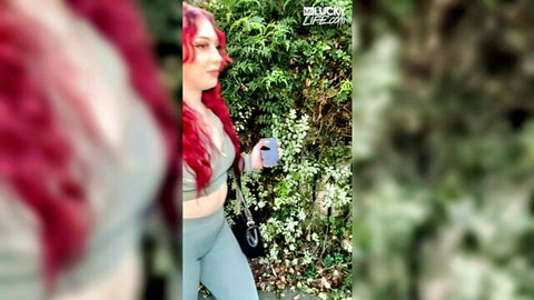 Arietta Adams redhead in green sports bra and leggings, outdoor POV tease