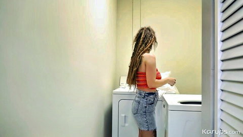 Indica Flower in tight denim shorts and red tube top, bending over