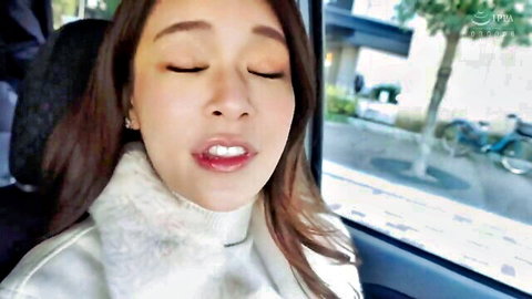 Seductive Asian JAV idol in white fuzzy sweater, close-up in car, glossy lips