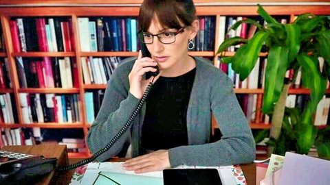 Brunette MILF in glasses on intense phone call, office vibe