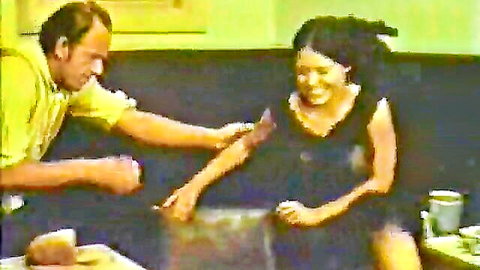Vintage Josefine Mutzenbacher scene: man injects laughing woman in black dress