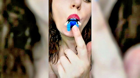Brunette giantess teases tiny LEGO figure with her red lips in fetish play