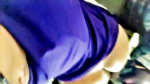 Curvy woman in purple dress with upskirt view showing white panties