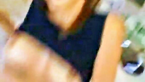 Daisy Marie in black dress with deep cleavage