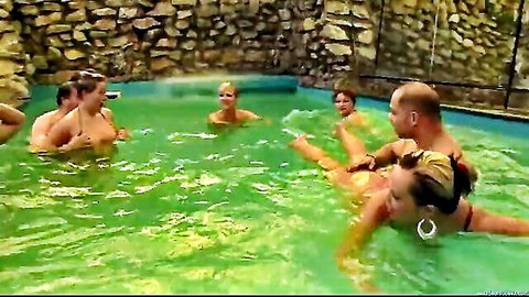 Nude group orgy in turquoise pool with busty blondes and men